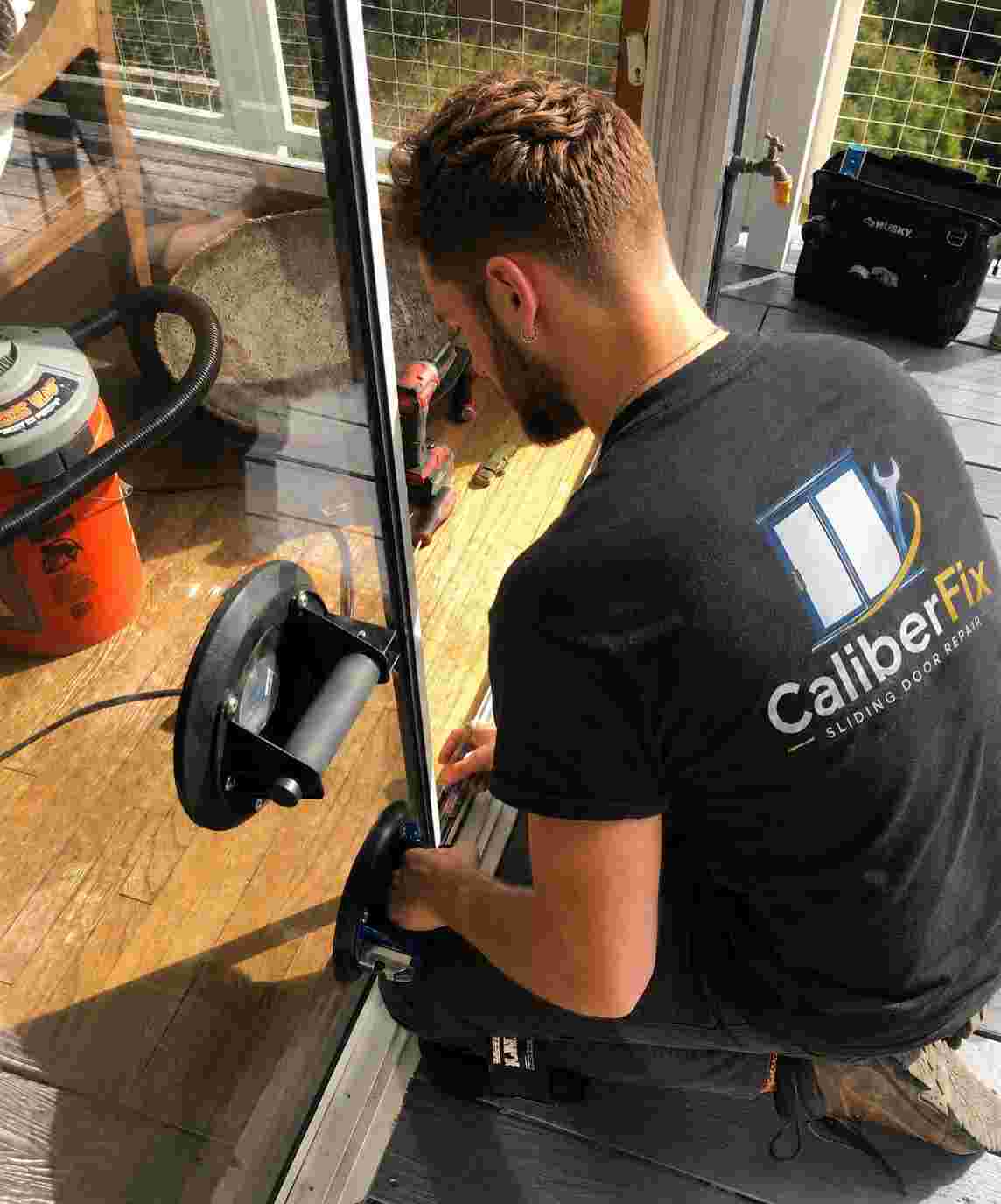 CaliberFix technician repairing a residential sliding glass door in Jacksonville
